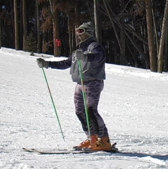 Skier standing tall with some flex in ankles and knees
