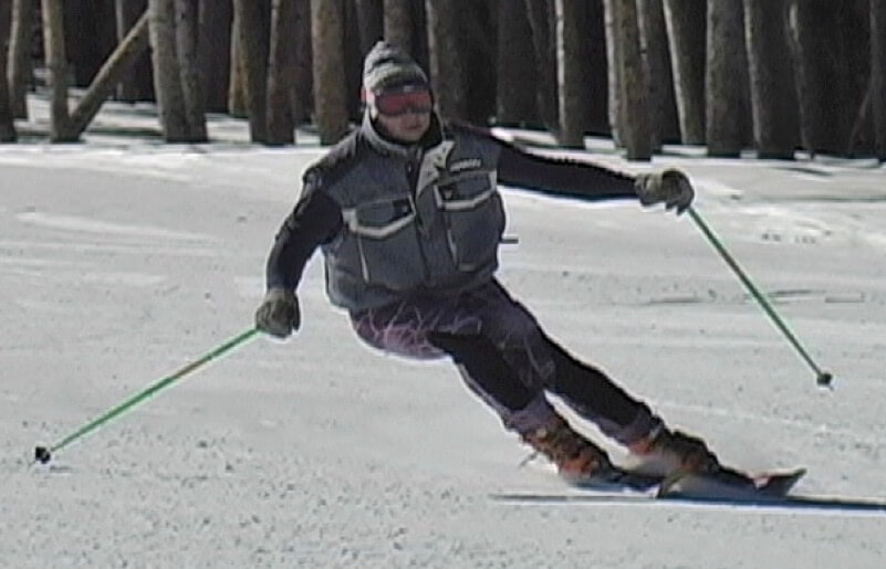 Skier in a turn with hips inside feet and angulated. Outside leg is long Inside leg is short. Skier is countered towards outside of turn.