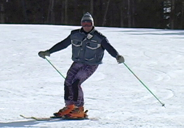 Photo of skier at start of turn . Upper body is facing downhill.
